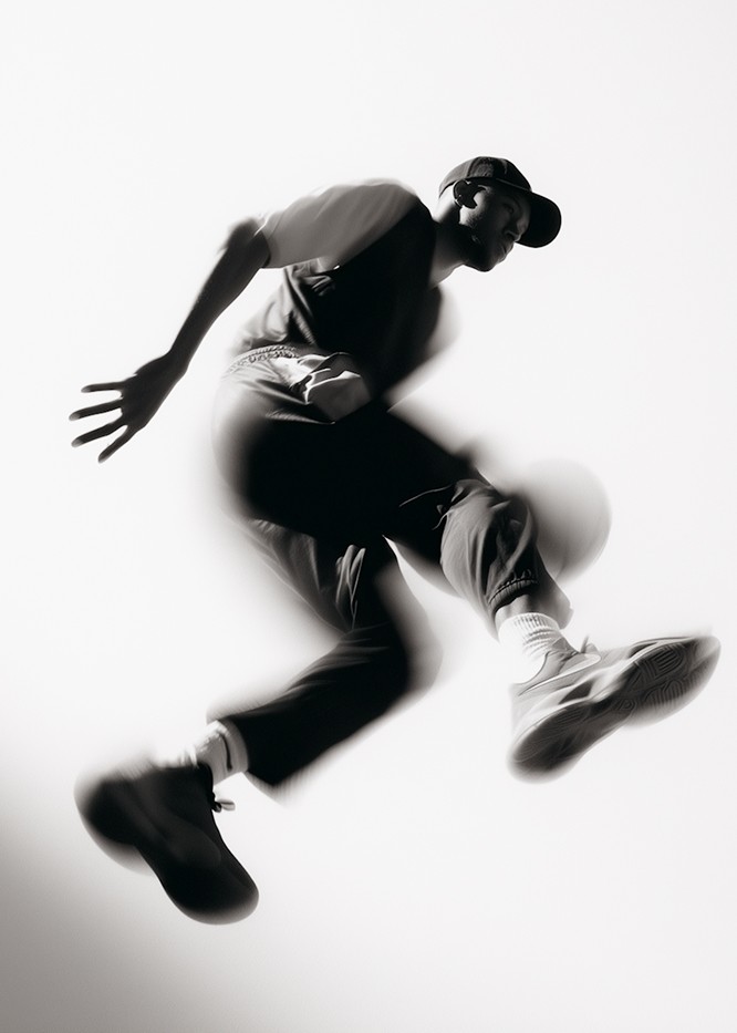 Athlete or dancer mid-leap in motion, photographed with a motion blur effect.