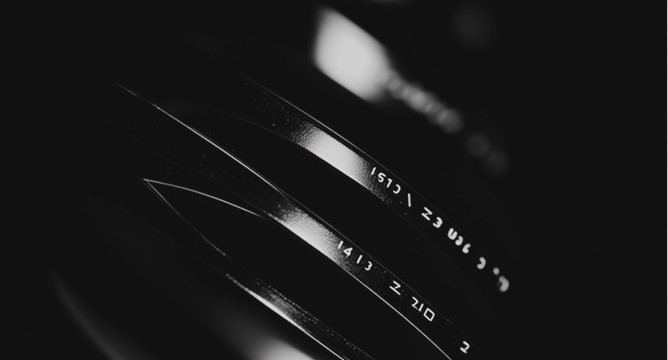 Close-up of camera lens in a dark environment.